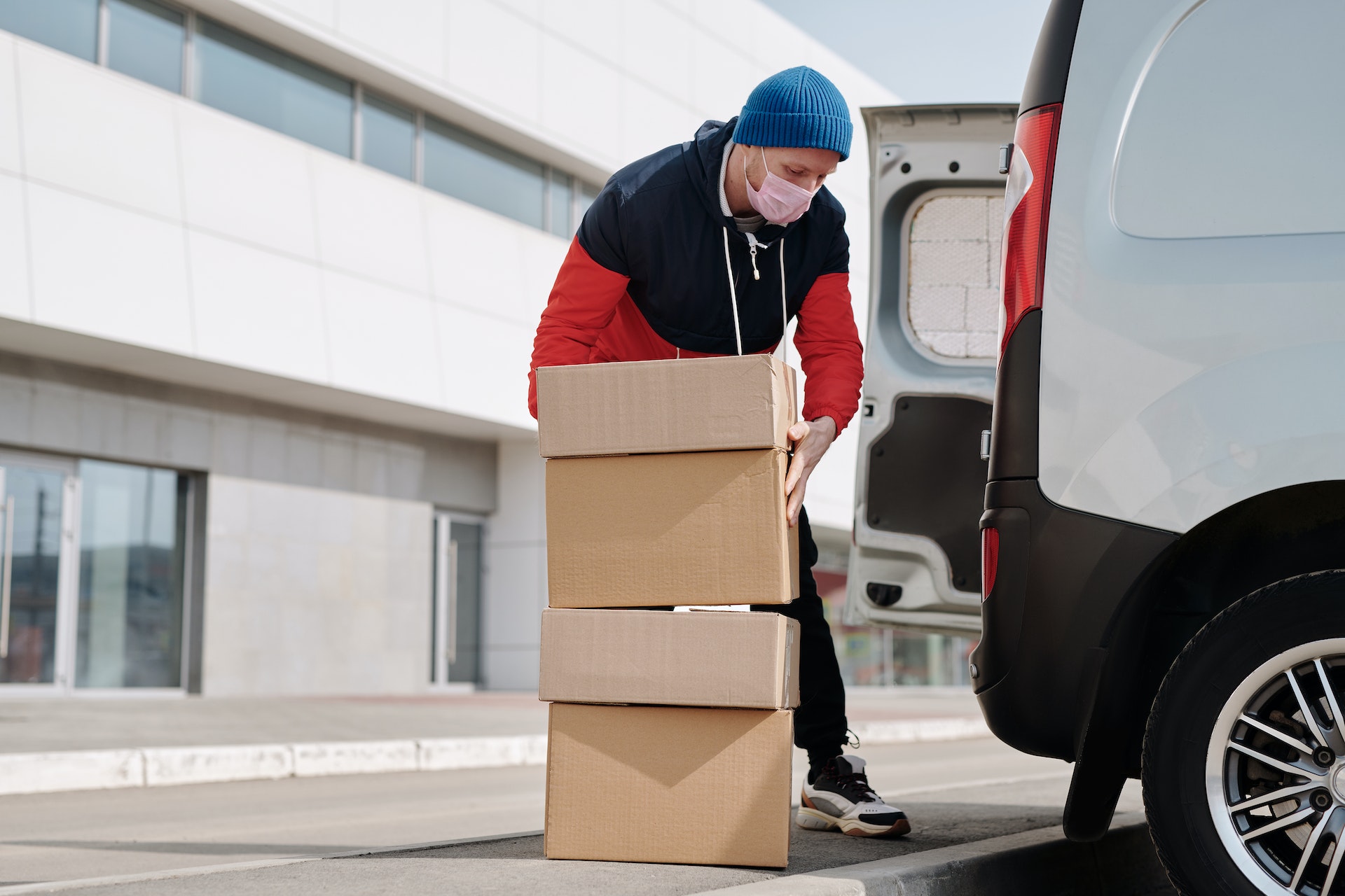A delivery man filling the van with packages